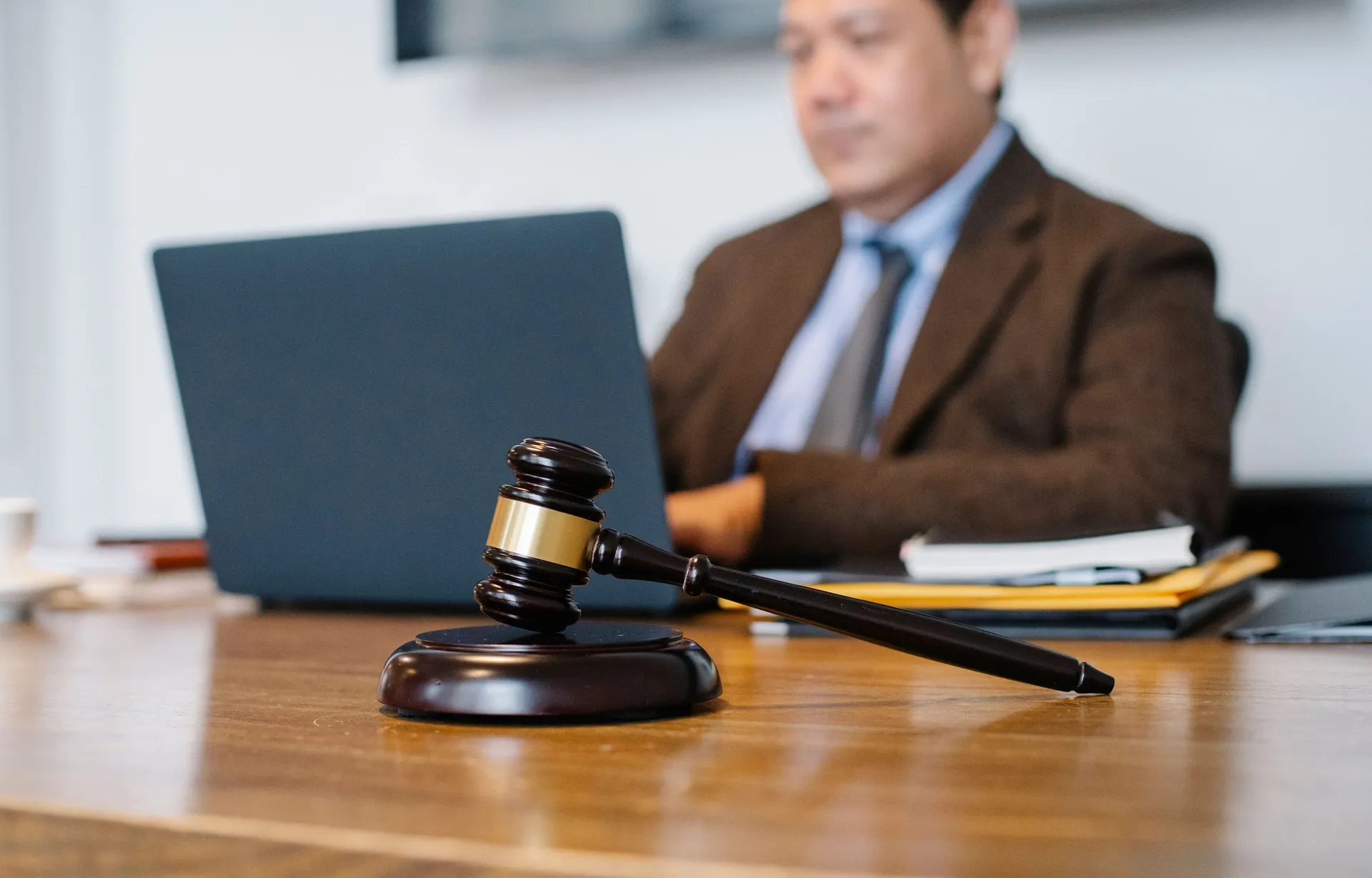 Wooden gavel on a polished desk in a law office