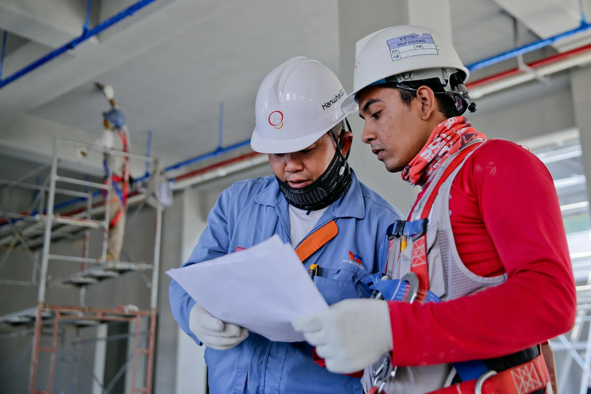 Two general contractors reviewing plans on a Northeast construction site